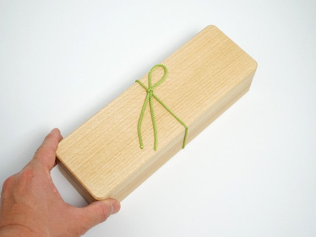 Holding the slim katsuobushi shaver in one hand