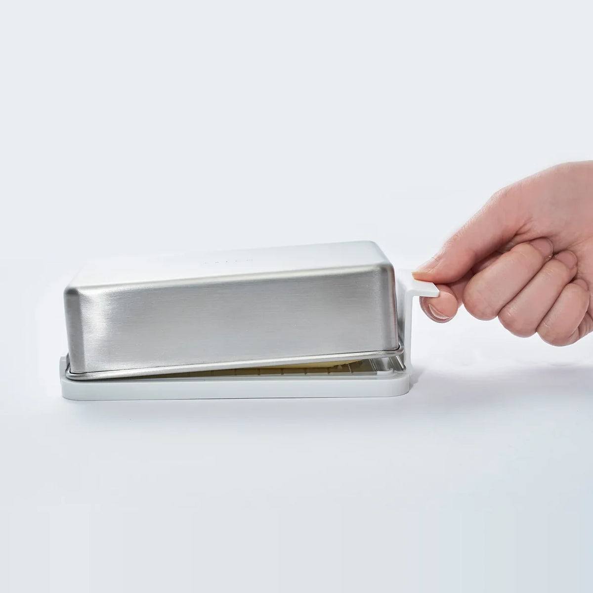 Placing the closed butter case on the table