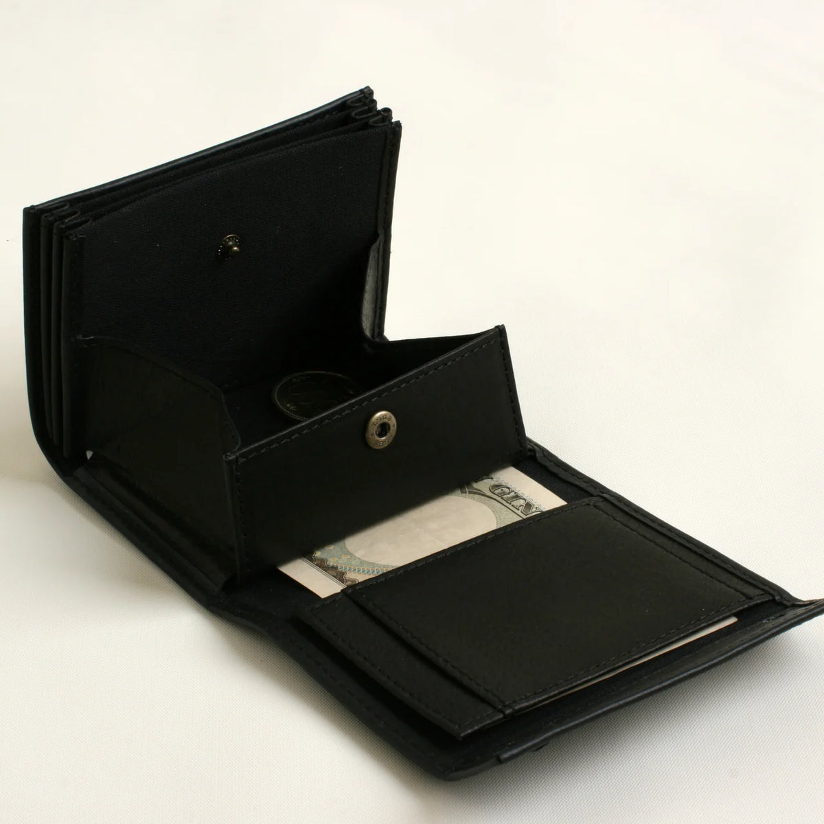 m+ millefoglie II wallet in black, opened to show the coin pocket and card slots