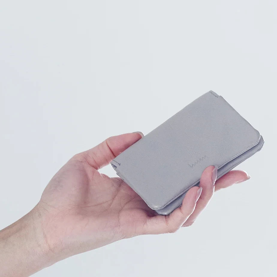 Holding a gray hmny leather card case