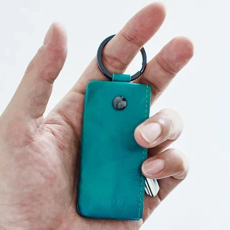 Holding a green hmny key case