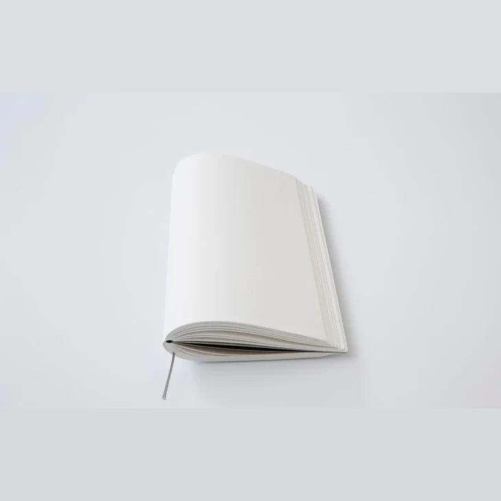 Thread-sewn ITO BINDERY notebook lying open flat