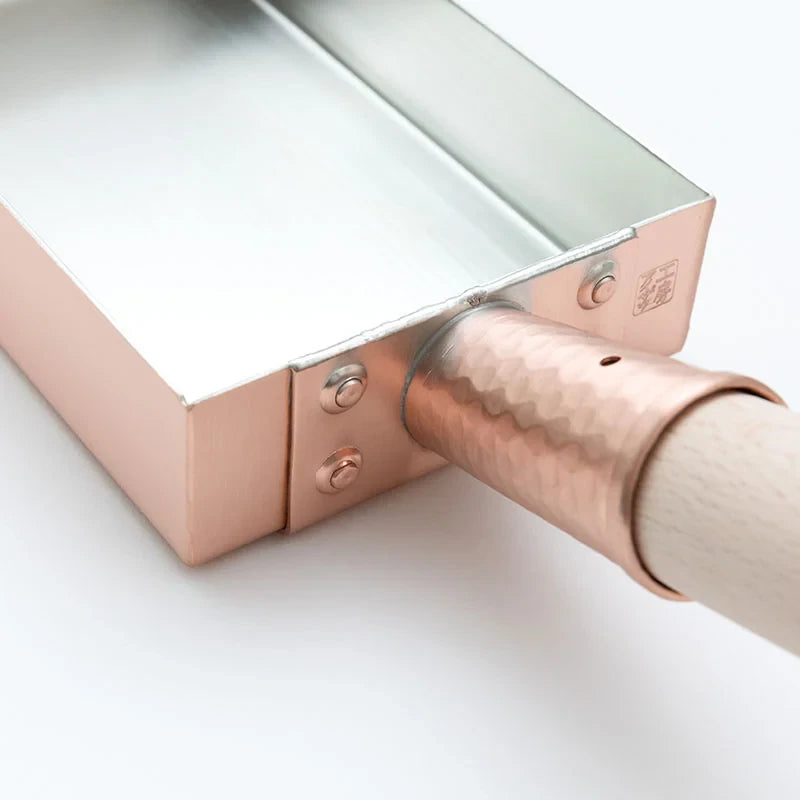 Close-up of the copper body and riveted handle socket