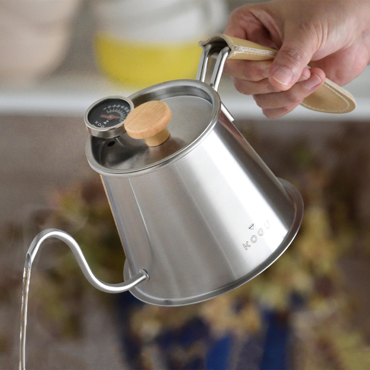 Close-up of the ultra-fine spout pouring a thin stream of water