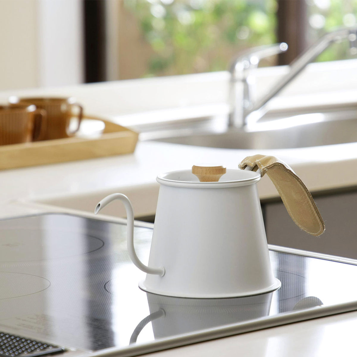 Matte white Two Drip Pot Pro with leather handle cover in a kitchen