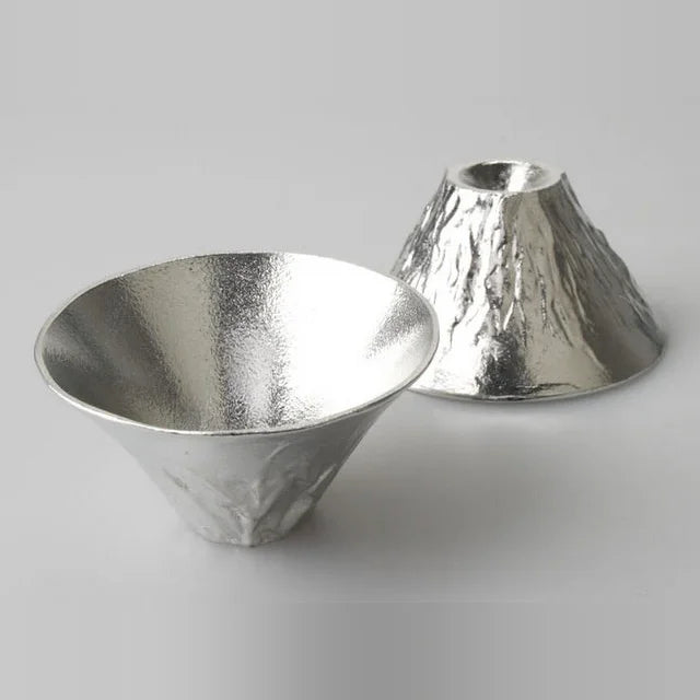 Two tin FUJIYAMA cups, one upright and one upside down