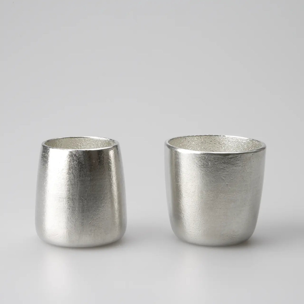 FUTAE pair of tin cups side by side