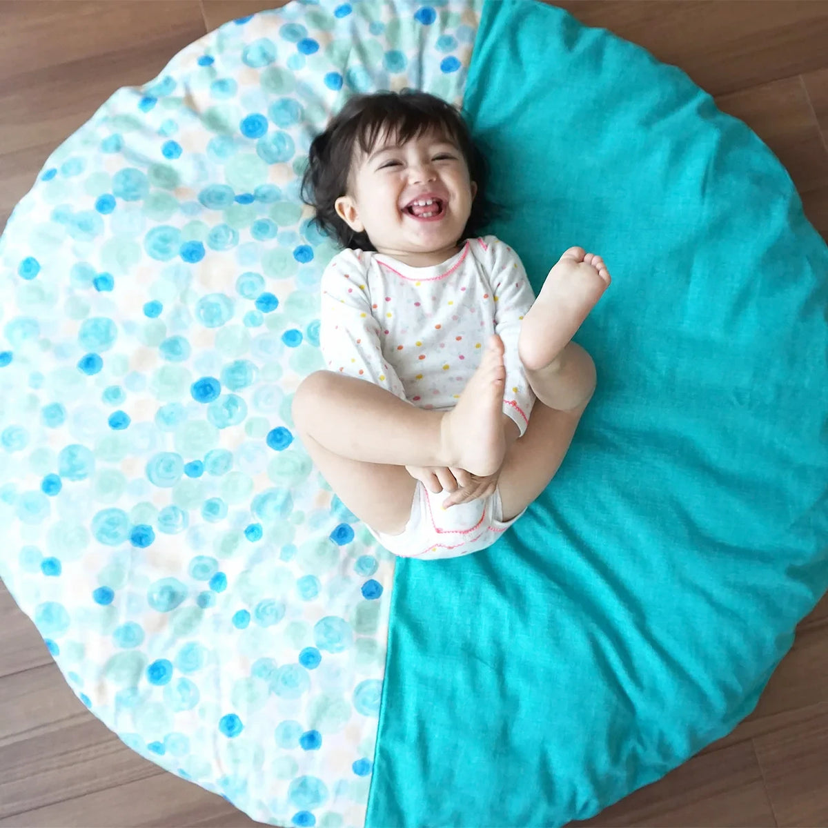 A toddler playing on the senbei floor cushion