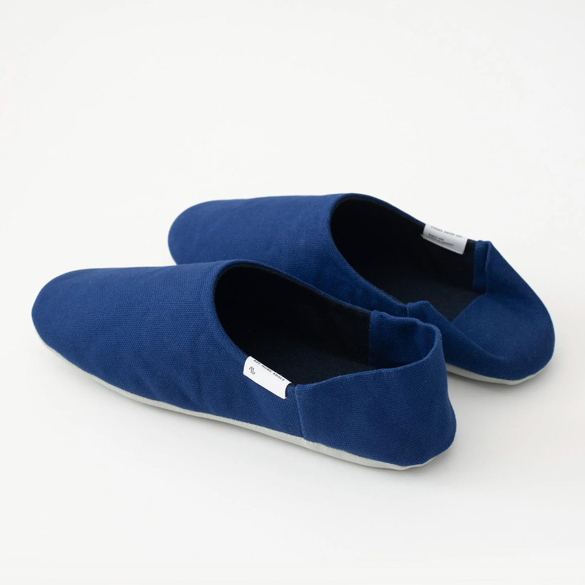 Ink blue canvas babouche, angled view #Color_Ink Blue