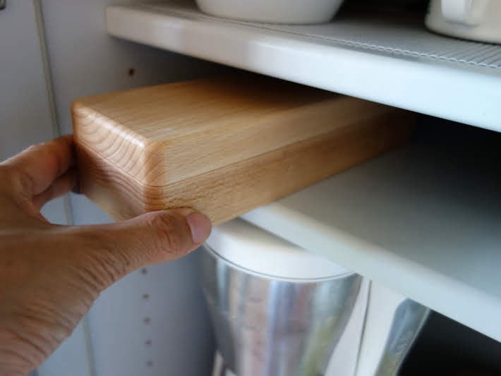 Compact katsuobushi shaver stored on a kitchen shelf