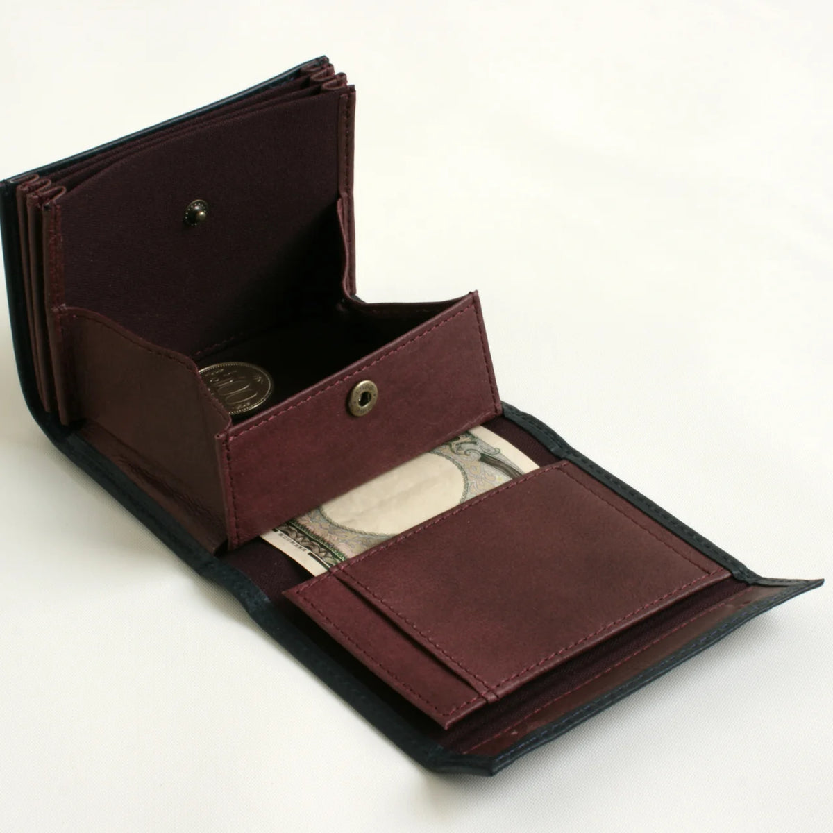 m+ millefoglie II wallet in navy, opened to show the coin pocket and card slots