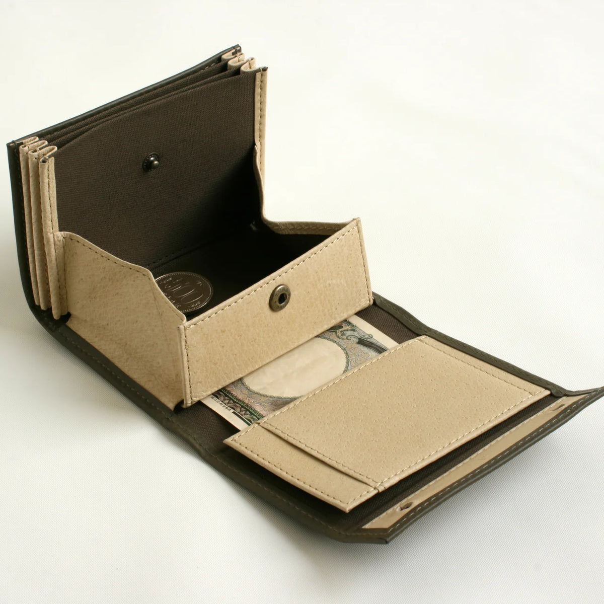 m+ millefoglie II wallet in grigio, opened to show the coin pocket and card slots