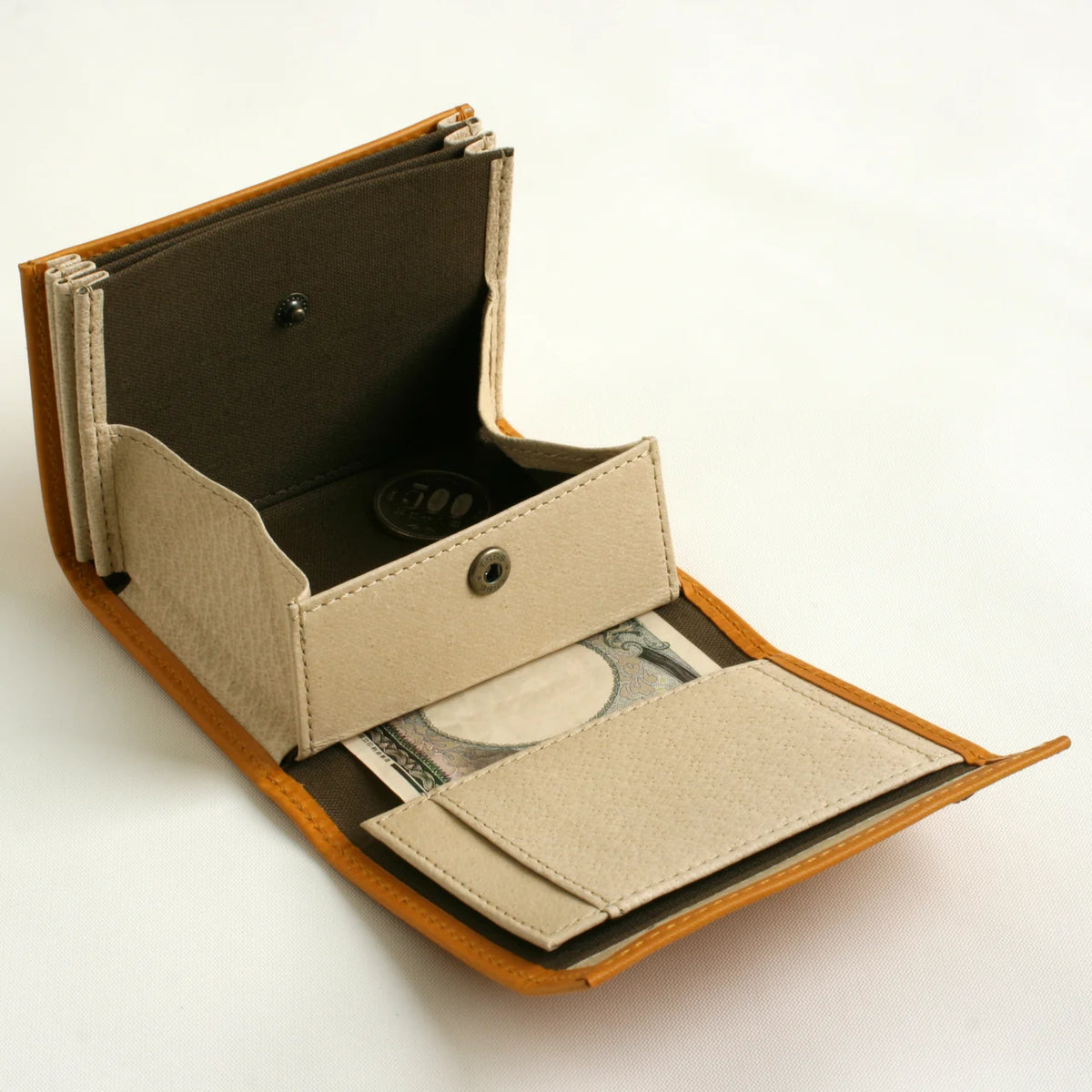 m+ millefoglie II wallet in napoli, opened to show the coin pocket and card slots