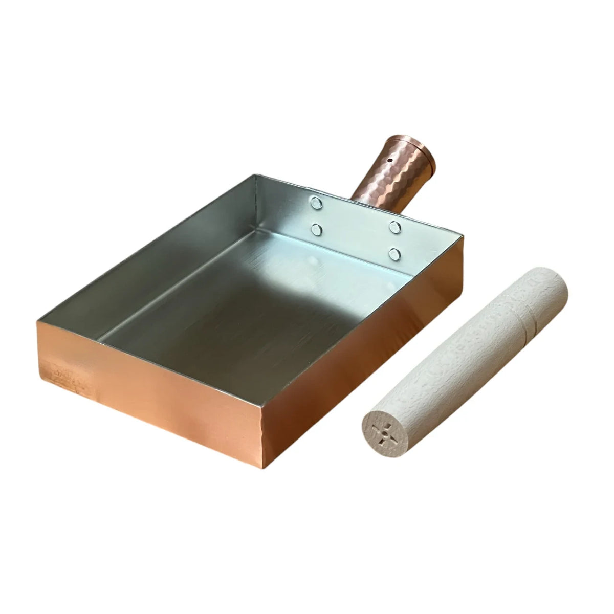 Copper tamagoyaki pan with the wooden handle before assembly