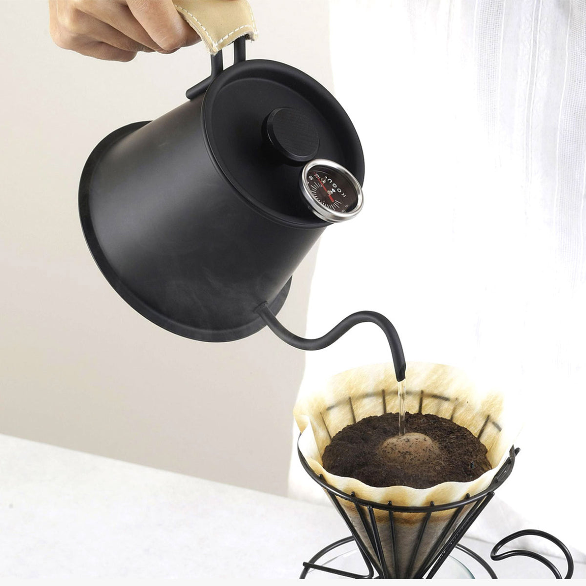 Matte black Two Drip Pot Pro pouring into a wire dripper