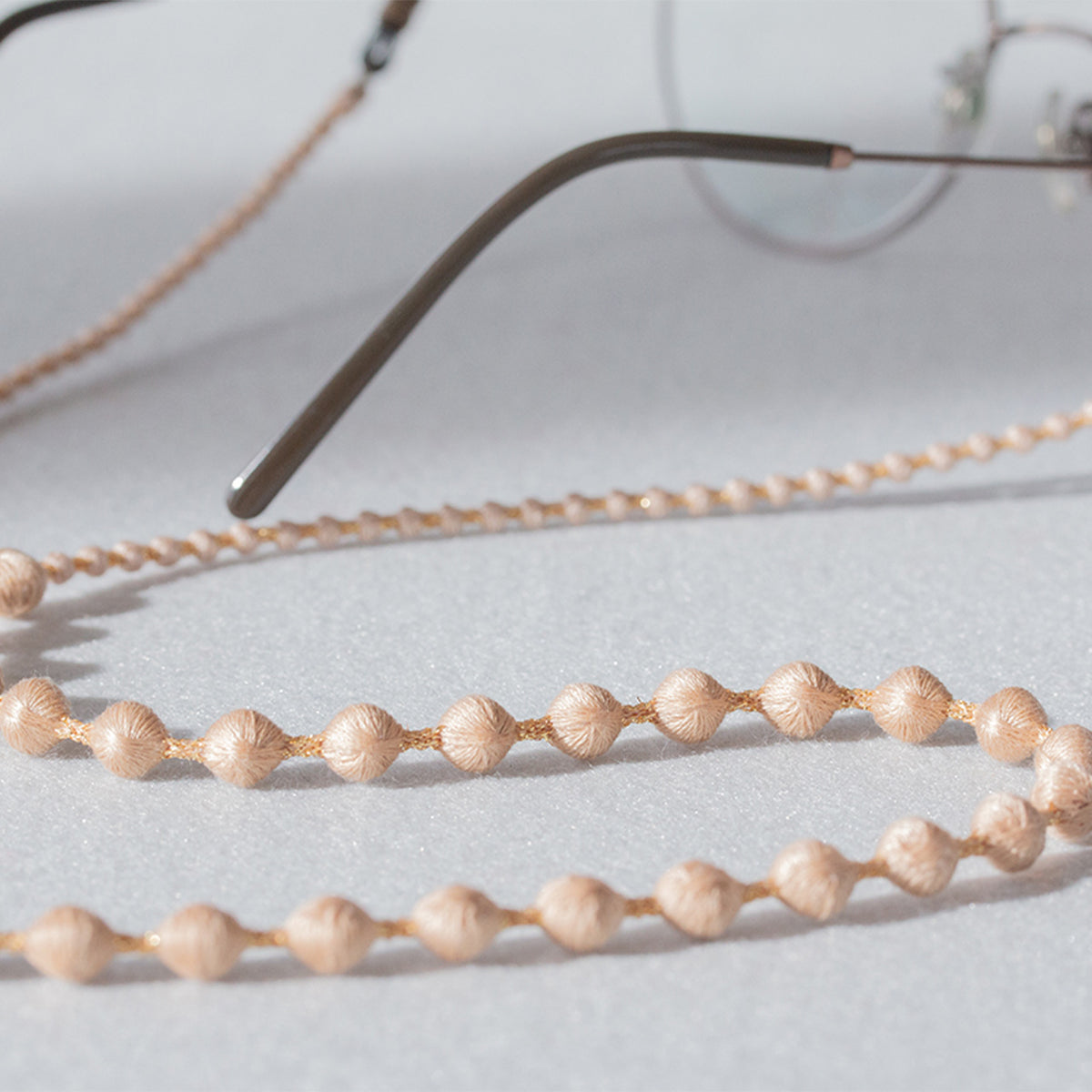 Close-up of the pink beaded cord on eyeglasses