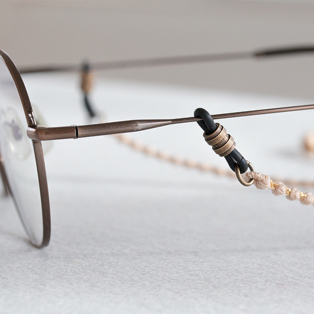 Close-up of the cord end attached to an eyeglass temple