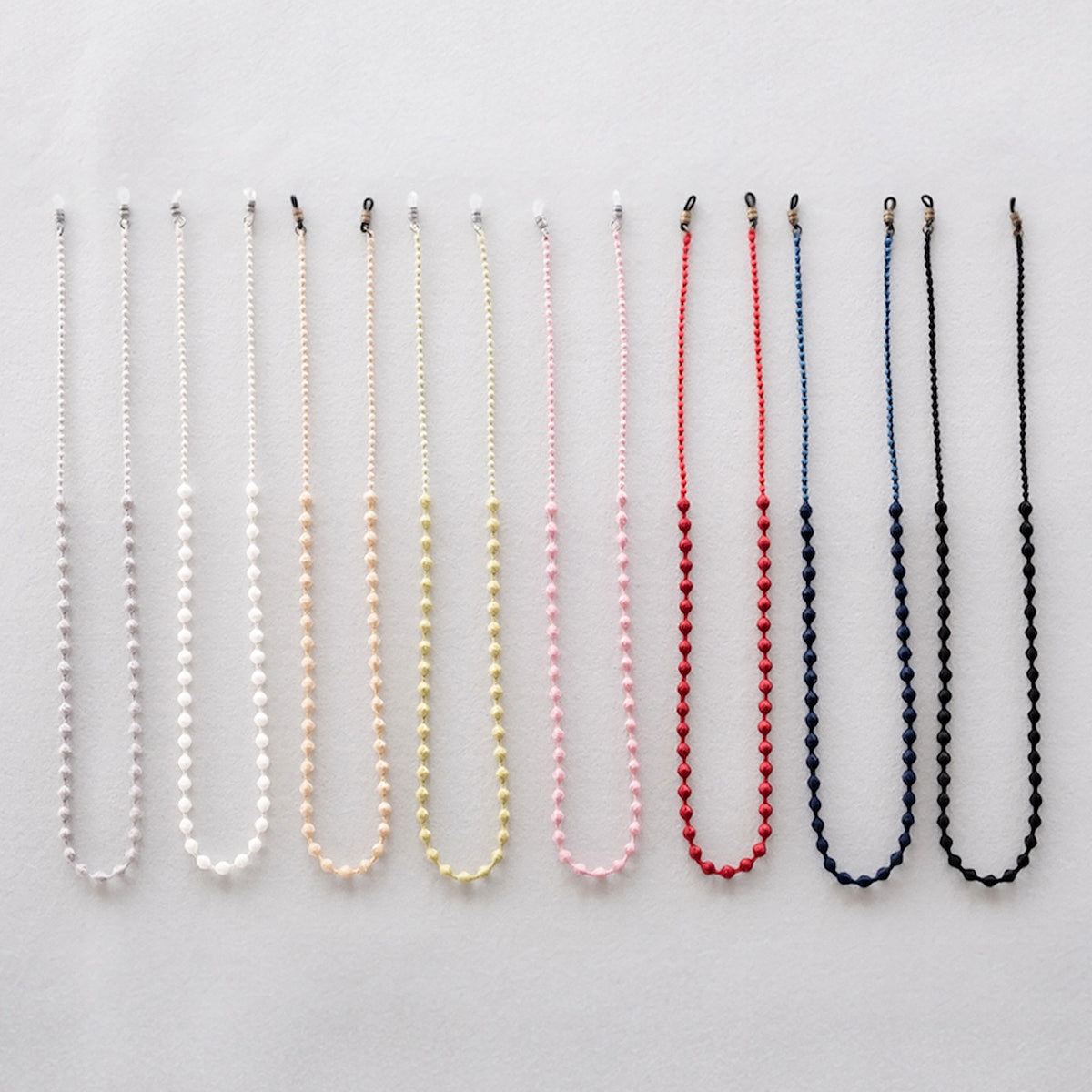 All eight colors of the beaded glasses cord hanging in a row