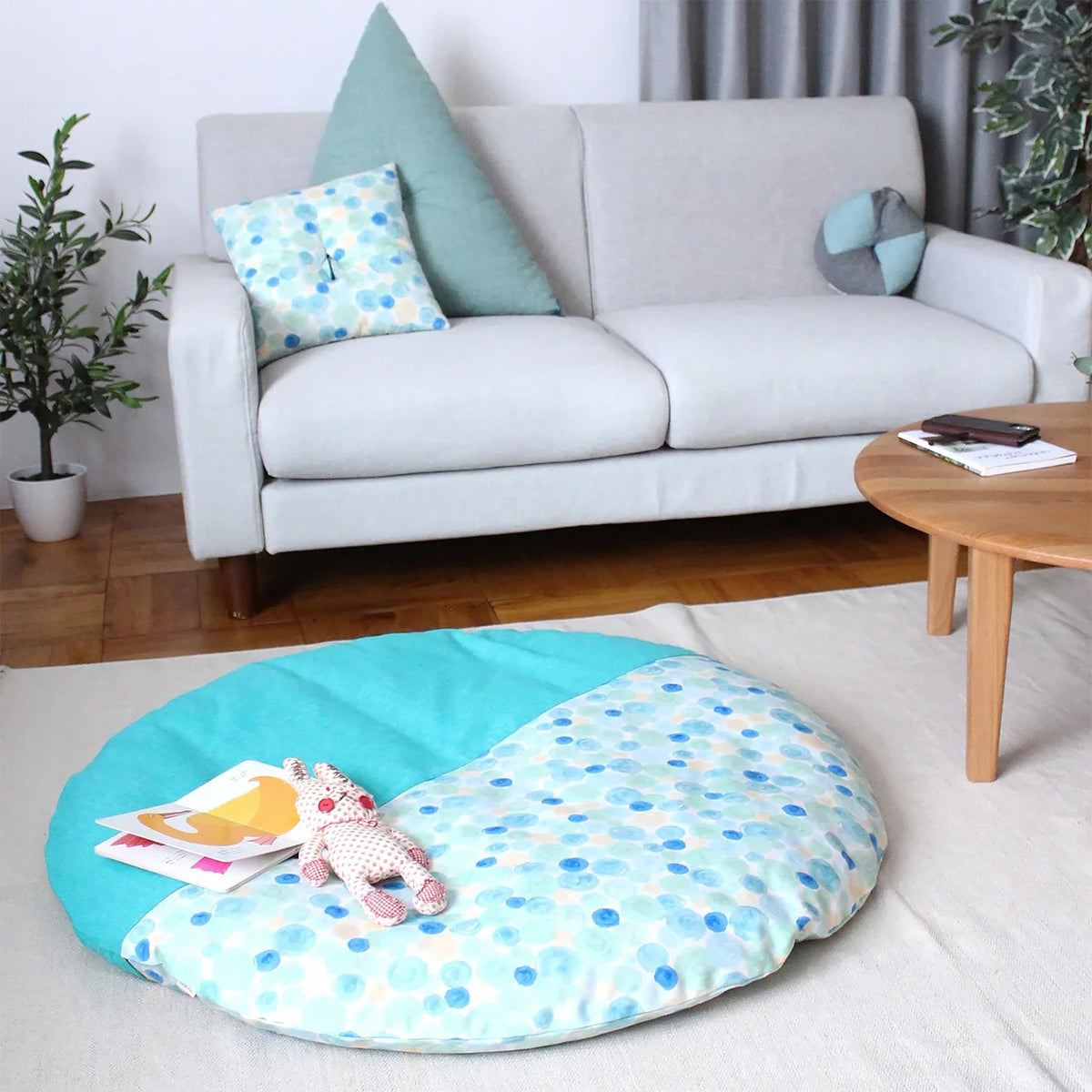 Senbei floor cushion in front of a sofa