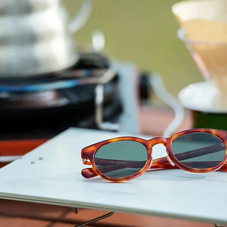 tesio YAMA sunglasses on a café table