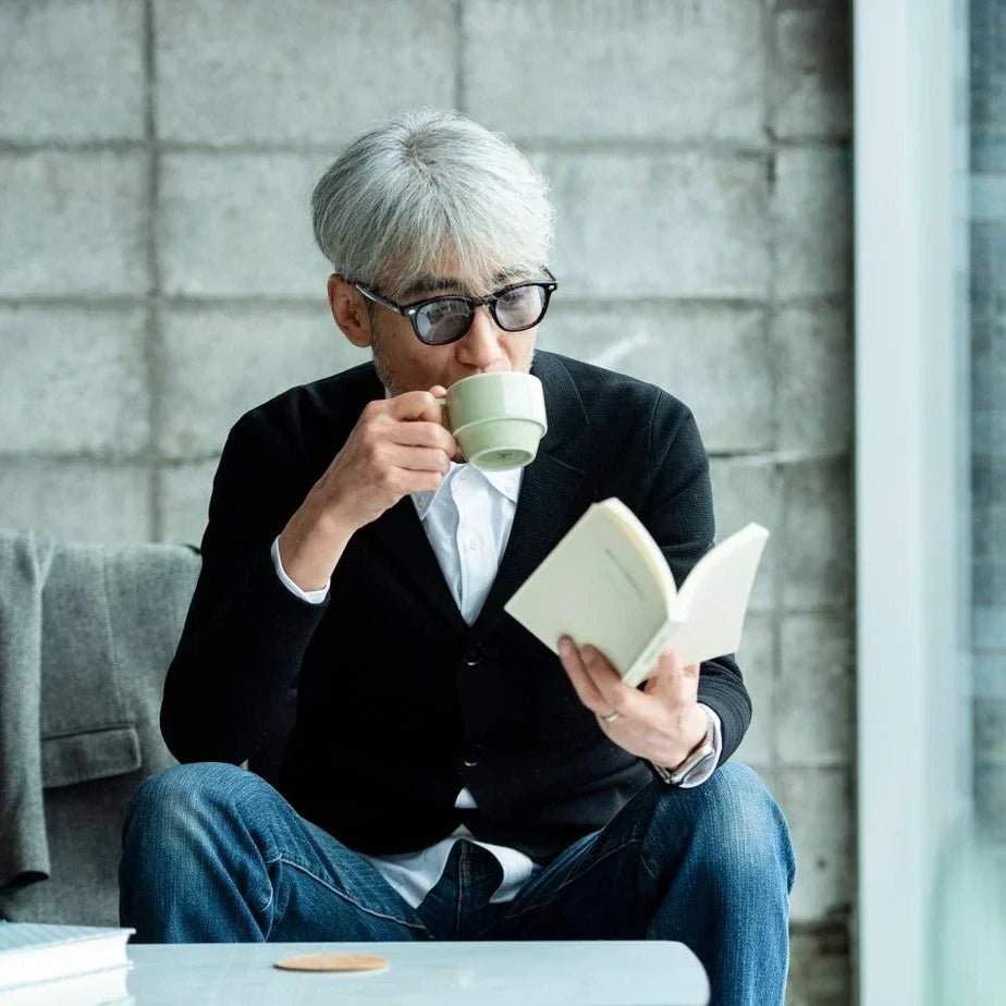 A man reading while wearing tesio KAEDE sunglasses