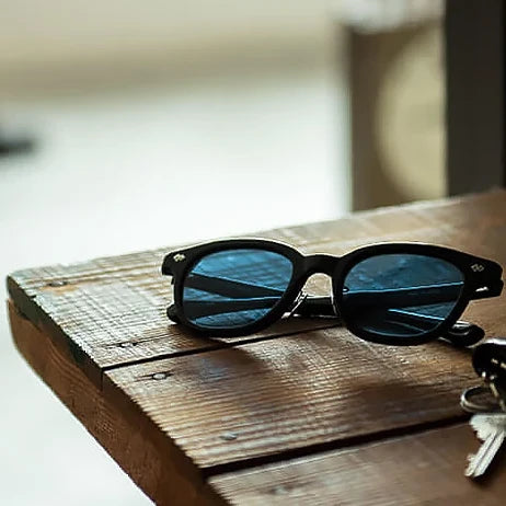 tesio MACHI sunglasses on a wooden table